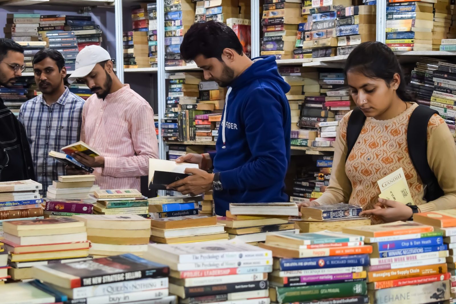 Visitors browse books at a book fair stall (demo photo)
