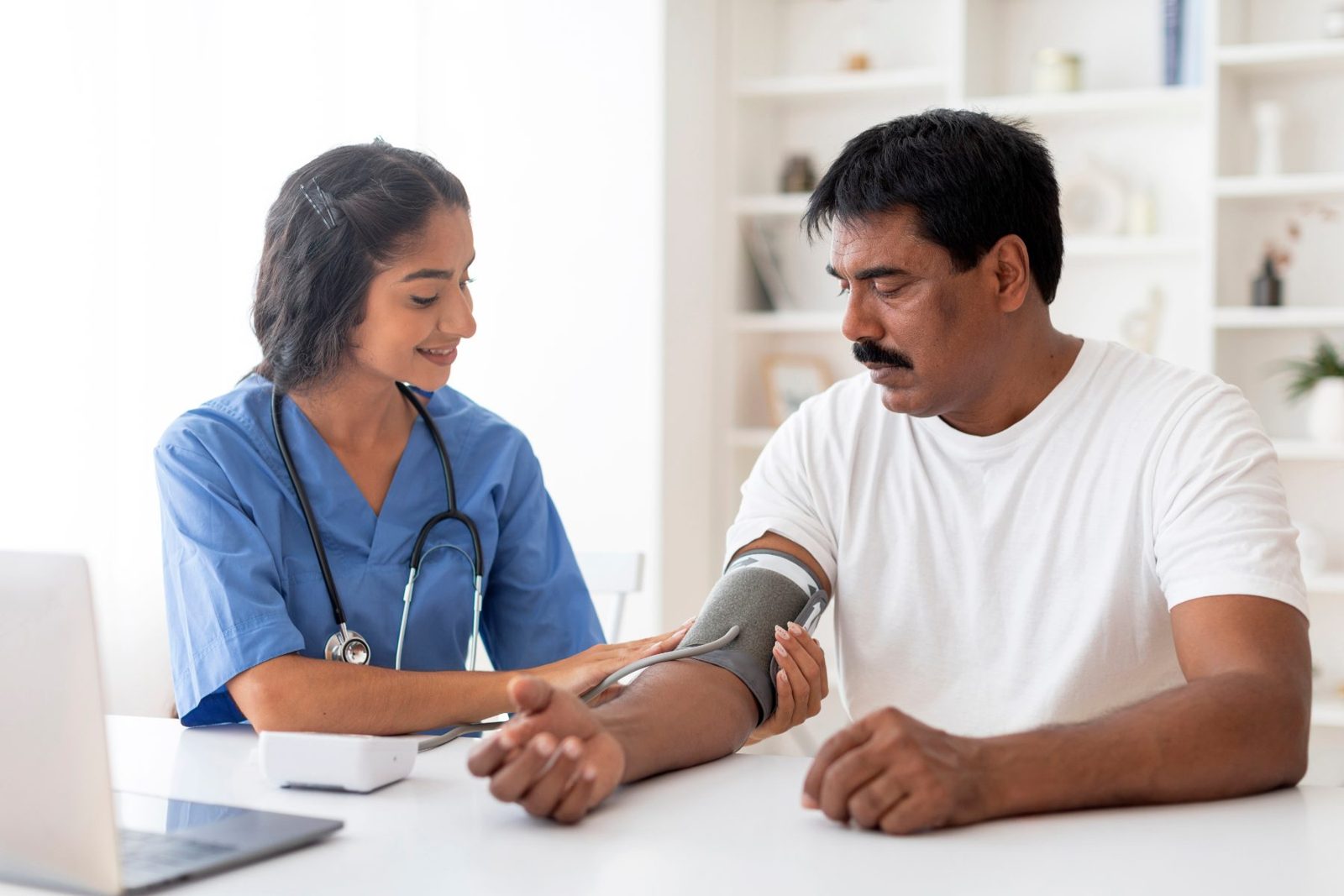 A doctor checks a man’s blood pressure (demo photo)